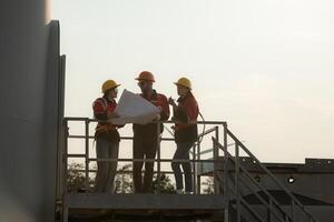 A group of engineers and architects work in floor of base ground of a wind turbine photo