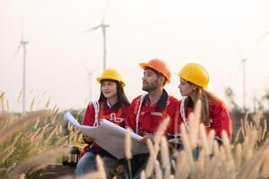 A group of engineers and architects work in floor of base ground of a wind turbine photo