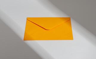 Bright orange envelope, paper letter, light beam and shadow photo