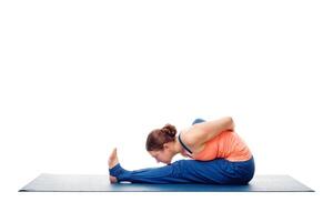 Woman doing Ashtanga Vinyasa Yoga asana Marichyasana A isolated photo