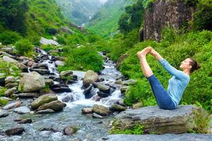 Woman doing Ashtanga Vinyasa Yoga asana outdoors photo