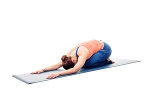 Woman doing Ashtanga Vinyasa Yoga relaxation asana Balasana chil photo