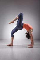 Beautiful sporty fit yogi girl practices yoga asana photo