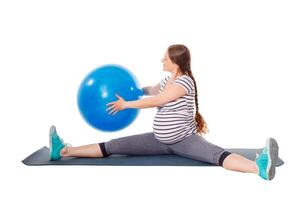 Pregnant woman doing exercises with exercise ball photo