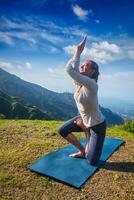 Woman doing Ashtanga Vinyasa yoga advanced asana photo