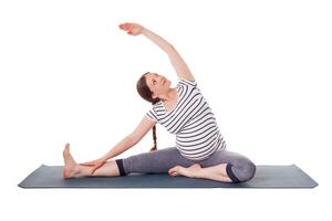 Pregnant woman doing yoga asana Parivrtta janu sirsasana photo