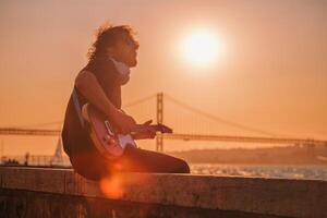 Street musician playing electric guitar in the street photo