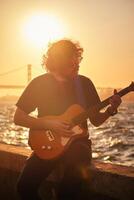 Street musician playing electric guitar in the street photo