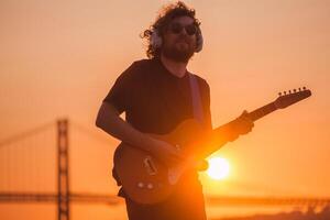 Street musician playing electric guitar in the street photo