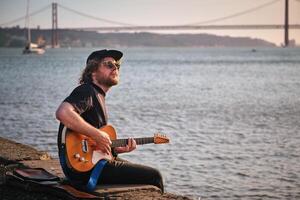 Street musician playing electric guitar in the street photo