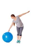 Pregnant woman doing exercises with exercise ball photo