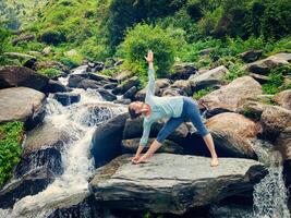 Woman doing Ashtanga Vinyasa yoga asana Utthita trikonasana photo