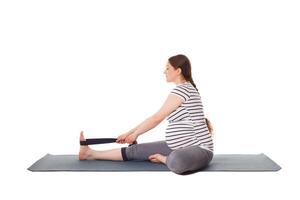 Pregnant woman doing yoga asana Janu Sirsasana A photo