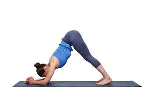 Woman doing Hatha yoga asana Ardha Pincha Mayurasana photo