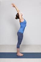 Woman doing Hatha Yoga asana Tadasana photo