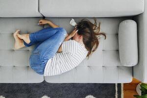 Distressed Woman Crying on Sofa photo