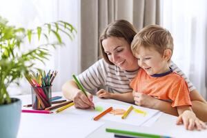 Joyful Mother and Child Drawing Together photo