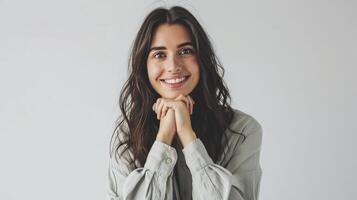 AI generated Portrait of smiling woman standing tied hands locking at camera on white background photo