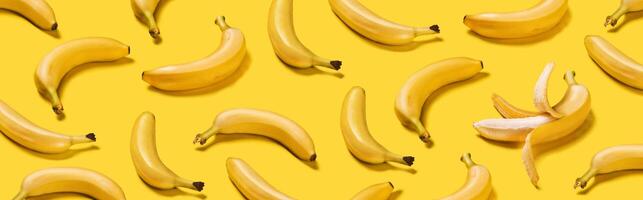 Banner bananas with hard shadows pattern on yellow background photo