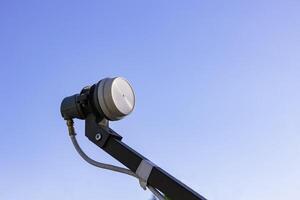 LNB on the feedhorn isolated on blue sky background photo