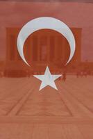 Turkish Flag with Anitkabir or mausoleum of Ataturk on the background. photo