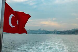 Turkish Flag and cityscape of Istanbul on the background photo