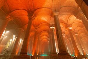 Vaults and columns of Basilica Cistern with orange light ambient photo