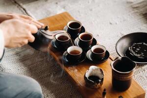 Close-up of pouring tea for a tea ceremony in a large company photo