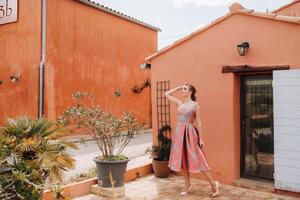 A young model girl in a beautiful dress in the countryside in France. Girl in the spring Provence village. photo