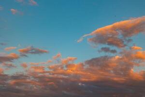 Partly cloudy sky at sunset or sunrise background or backdrop photo