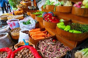 A street market or greengrocer with fresh vegetables or fruits. photo