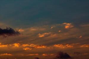 Partly cloudy sky at sunset with sunrays photo