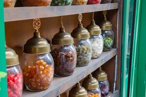 Jars of candies on the shelves of a candy store or shop photo