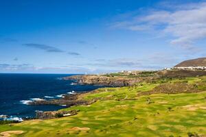 Golf course near the Atlantic ocean in Tenerife, Spain, green Golf course, tennis court in the nature of Tenerife photo