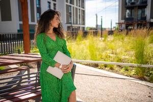 Caucasian woman with laptop computer outside office. photo