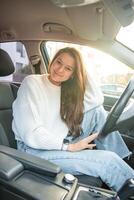 Portrait of young woman inside car interior. The car as a place in which a significant part of people lives passes. High quality photo