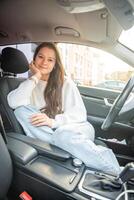 Portrait of young woman inside car interior. The car as a place in which a significant part of people lives passes photo