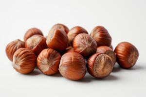 ai generado un pila de nueces aislado en blanco antecedentes un fotografía de un pila de nueces pulcramente arreglado en parte superior de un blanco mesa. foto