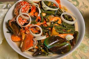 a bowl of food with seafood and vegetables photo