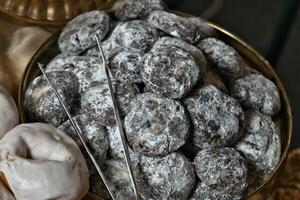 a bowl of powdered sugar cookies and a spoon photo