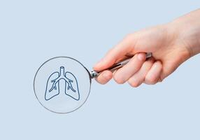 Lungs health checkup, study through magnifying glass photo