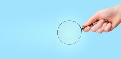 Magnifying glass in hand for search, research, find, banner background with copy space for text photo