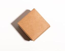 Small kraft box, square shaped package closed with lid, top view photo