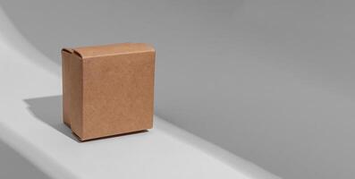 Kraft carton box cover of square shape, cardboard package. Banner background photo