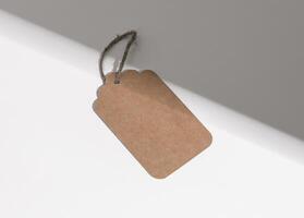 Kraft paper tag, carton label, sale blank card on rope, twine photo