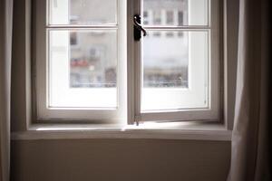 Vintage wooden white frame window. Light in the window photo