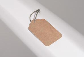 Brown paper tag, eco cardboard label mock up, blank card on rope, twine photo