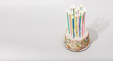 Birthday bento cake with high tall candles, fire light. Banner background, copy space for text photo