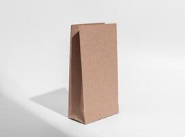 Brown kraft paper bag mock up. Craft pouch, package, vertical packet, angle view photo