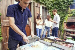 group of friends preparing a barbecue party photo